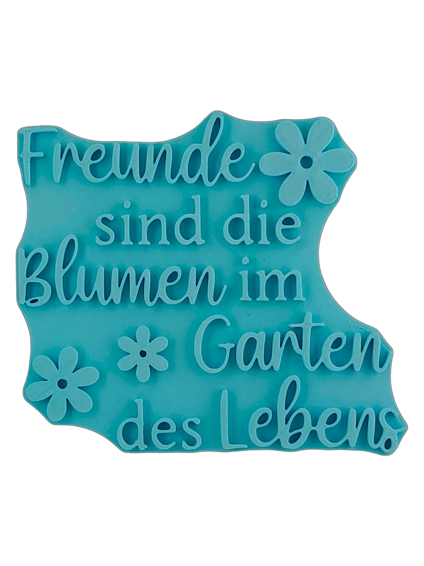 Blaugrüner Textstempel für Ton mit dem Spruch 'Freunde sind die Blumen im Garten des Lebens'. Hochwertiges Töpferwerkzeug mit Blumen-Motiven für saubere Prägungen in Keramik.
