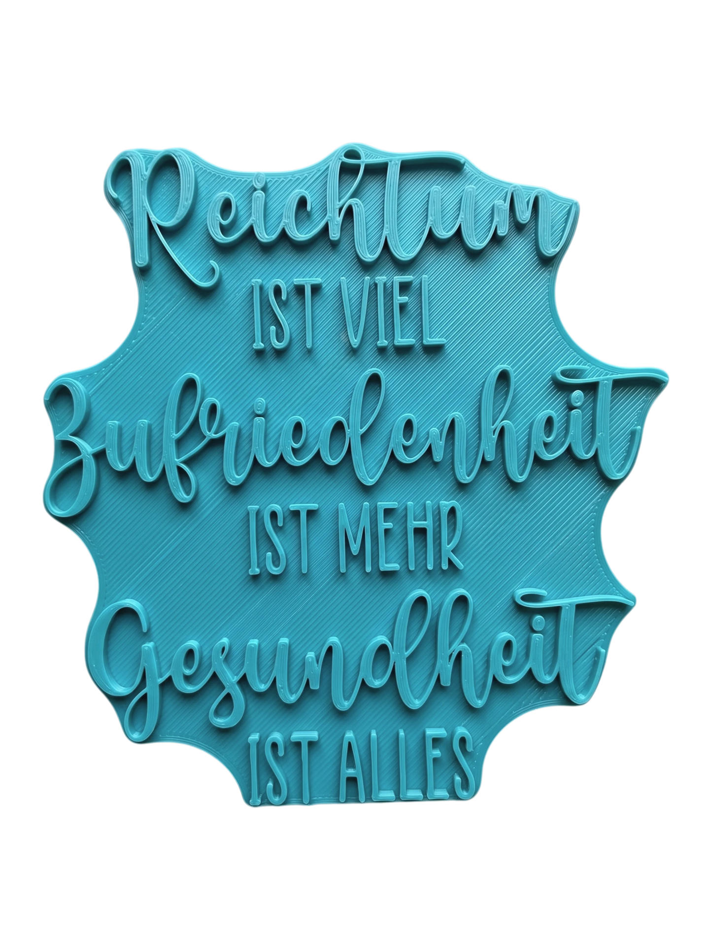 Türkisfarbener Keramikstempel für Ton mit dem Spruch 'Reichtum ist viel, Zufriedenheit ist mehr, Gesundheit ist alles'. Hochwertiges Töpferwerkzeug für präzise Textprägungen.