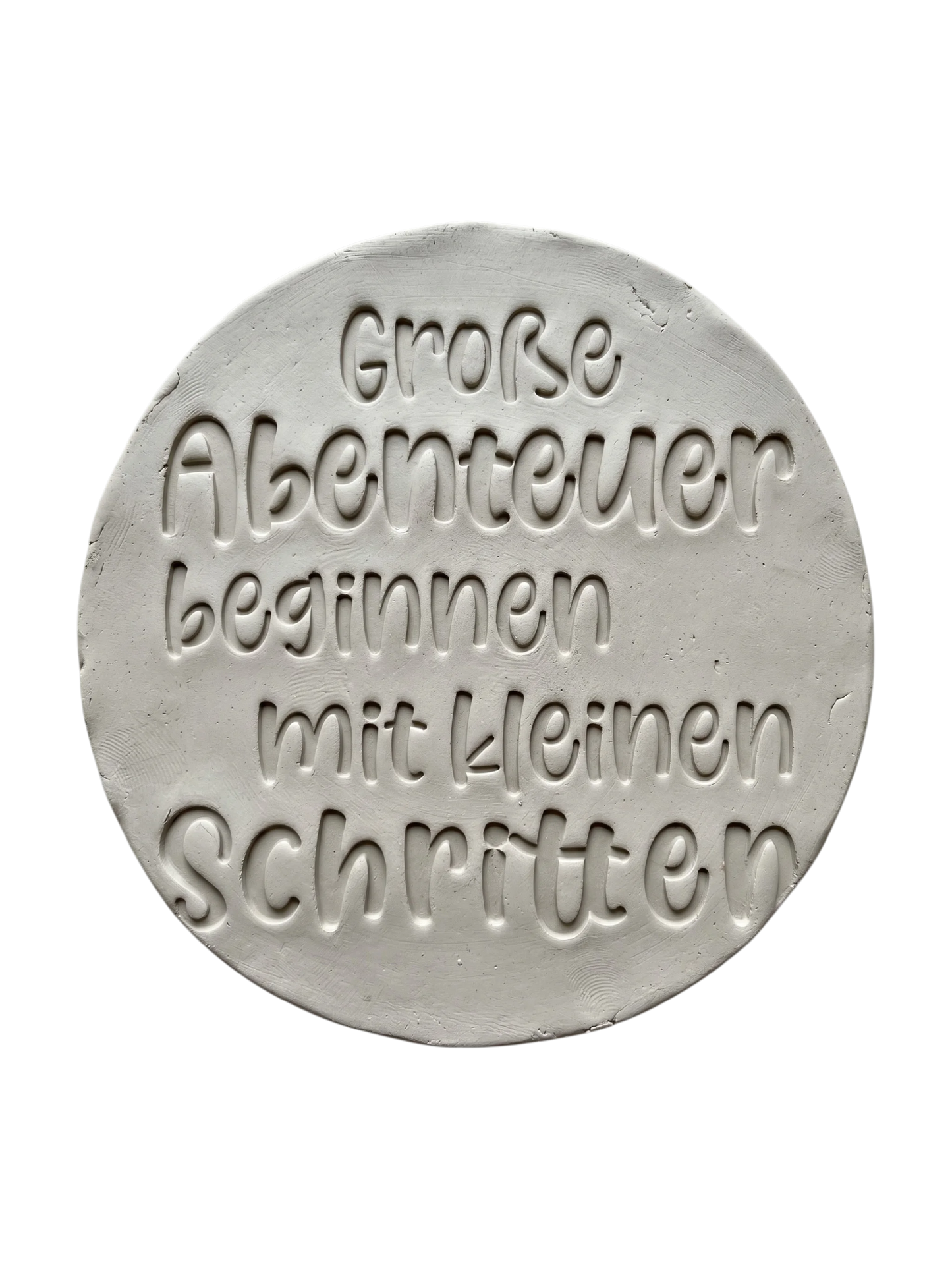 Detailreicher Abdruck im Ton mit dem Spruch 'Große Abenteuer beginnen mit kleinen Schritten'. Erstellt mit einem MinseArt Keramikstempel. Saubere Schriftzüge und präzise Konturen für deine nächste Töpfer-Idee im Bereich Baby-Geschenke und Kinderzimmer-Deko.