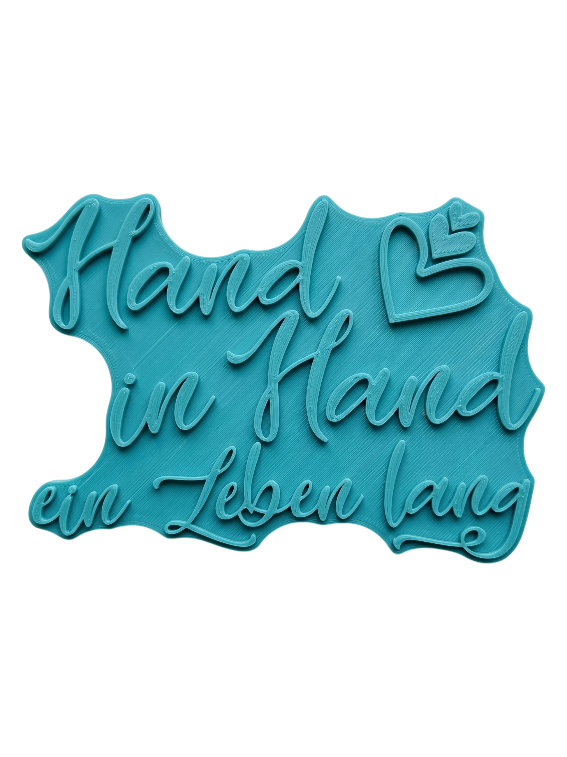 Türkisfarbener Keramikstempel für Ton mit dem romantischen Schriftzug 'Hand in Hand ein Leben lang' und kleinen Herzen. Hochwertiges Töpferwerkzeug für Hochzeitsgeschenke und liebevolle Keramikprojekte.