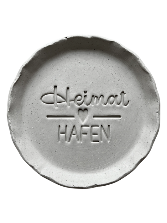 Präziser Abdruck im hellen Ton mit dem Motiv 'Heimathafen'. Kreative Töpfer-Idee für maritime Wandteller, Türschilder oder Geschenke zum Einzug.