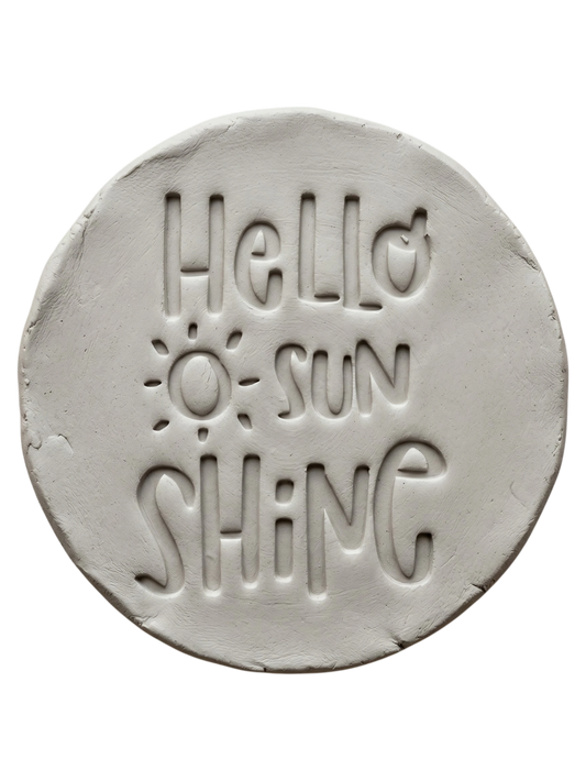Präziser Stempelabdruck 'Hello sunshine' in hellem Ton. Die verspielte Schrift und das Sonnen-Motiv sorgen für ein klares Relief auf handgemachter Keramik.