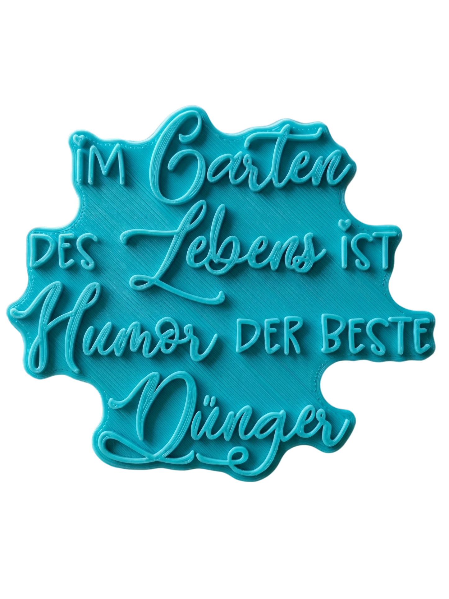 Türkisfarbener Keramikstempel für Ton mit dem Spruch 'Im Garten des Lebens ist Humor der beste Dünger'. Handgefertigtes Töpferwerkzeug für lustige Gartendeko.
