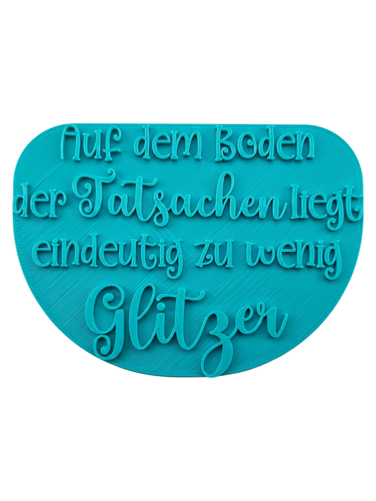 Türkisfarbener Keramikstempel für Ton mit dem Spruch 'Auf dem Boden der Tatsachen liegt eindeutig zu wenig Glitzer'. Hochwertiges Töpferwerkzeug für humorvolle Prägungen.