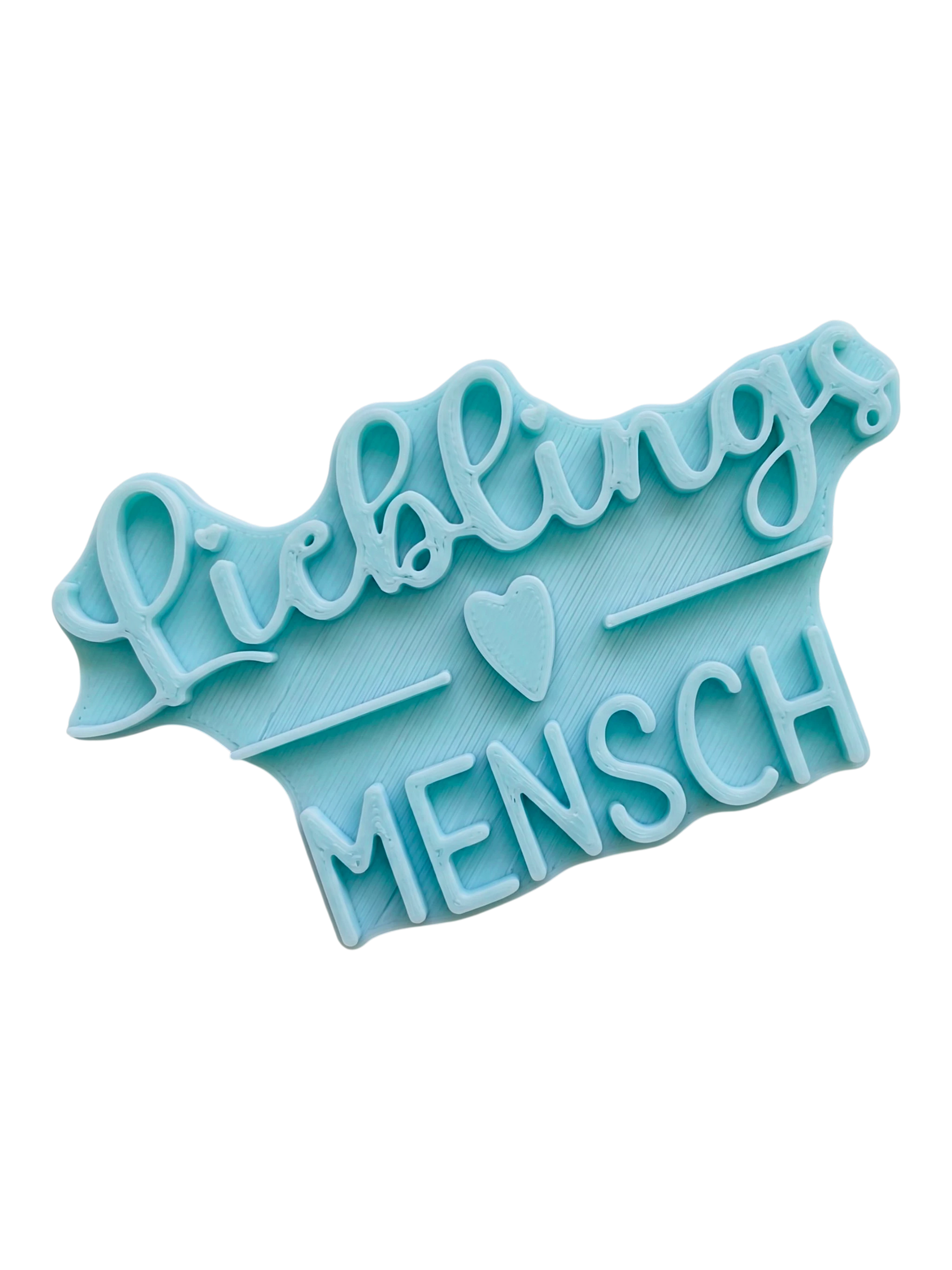 Blaugrüner Textstempel für Ton mit dem Schriftzug 'Lieblingsmensch' und Herz-Detail. Hochwertiges Töpferwerkzeug für saubere Prägungen in Keramik.