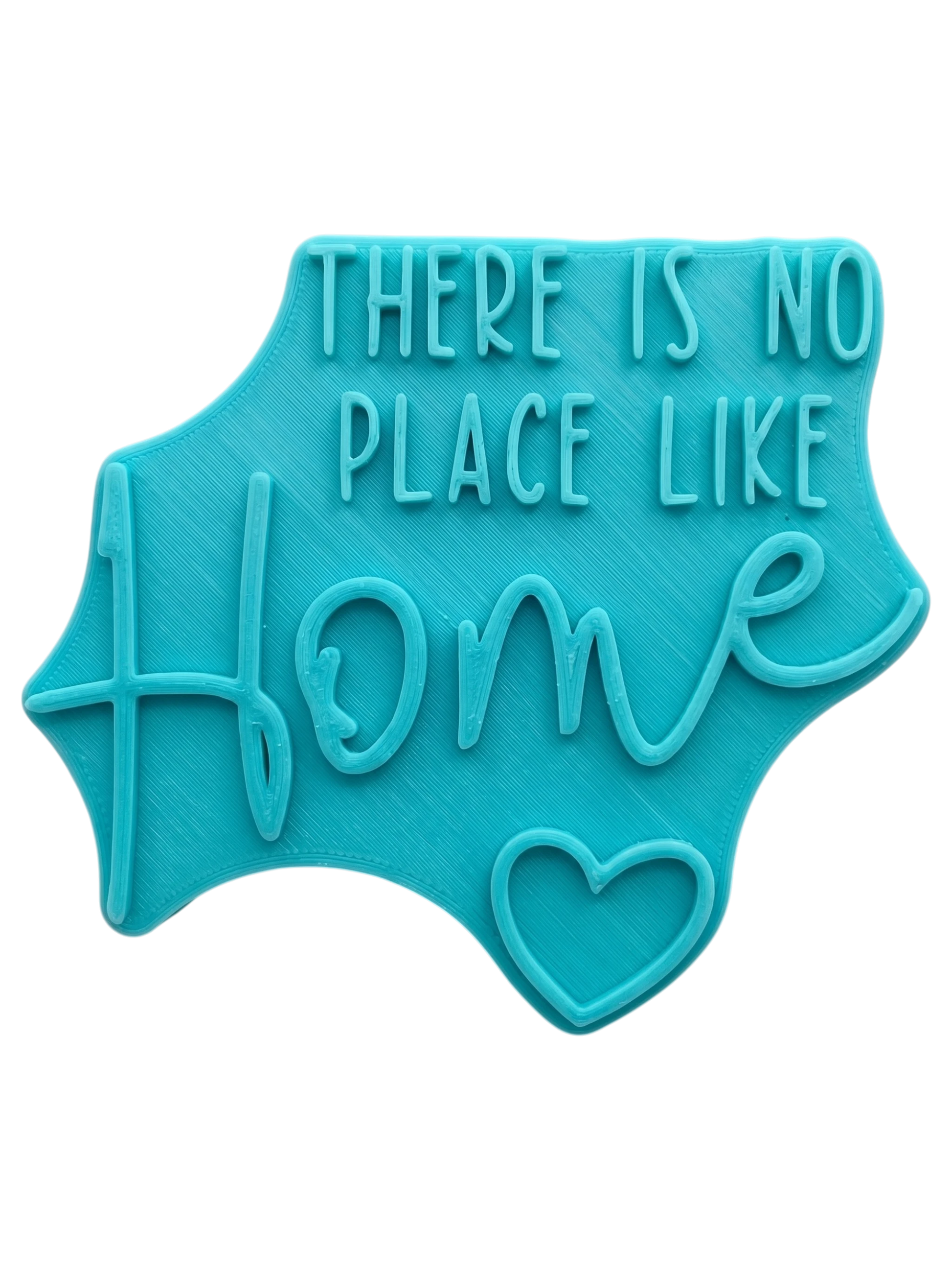 Rosafarbener Keramikstempel für Ton mit dem Schriftzug 'There is no place like Home' und Herz-Detail. Hochwertiges Töpferwerkzeug für individuelle Hausschilder.