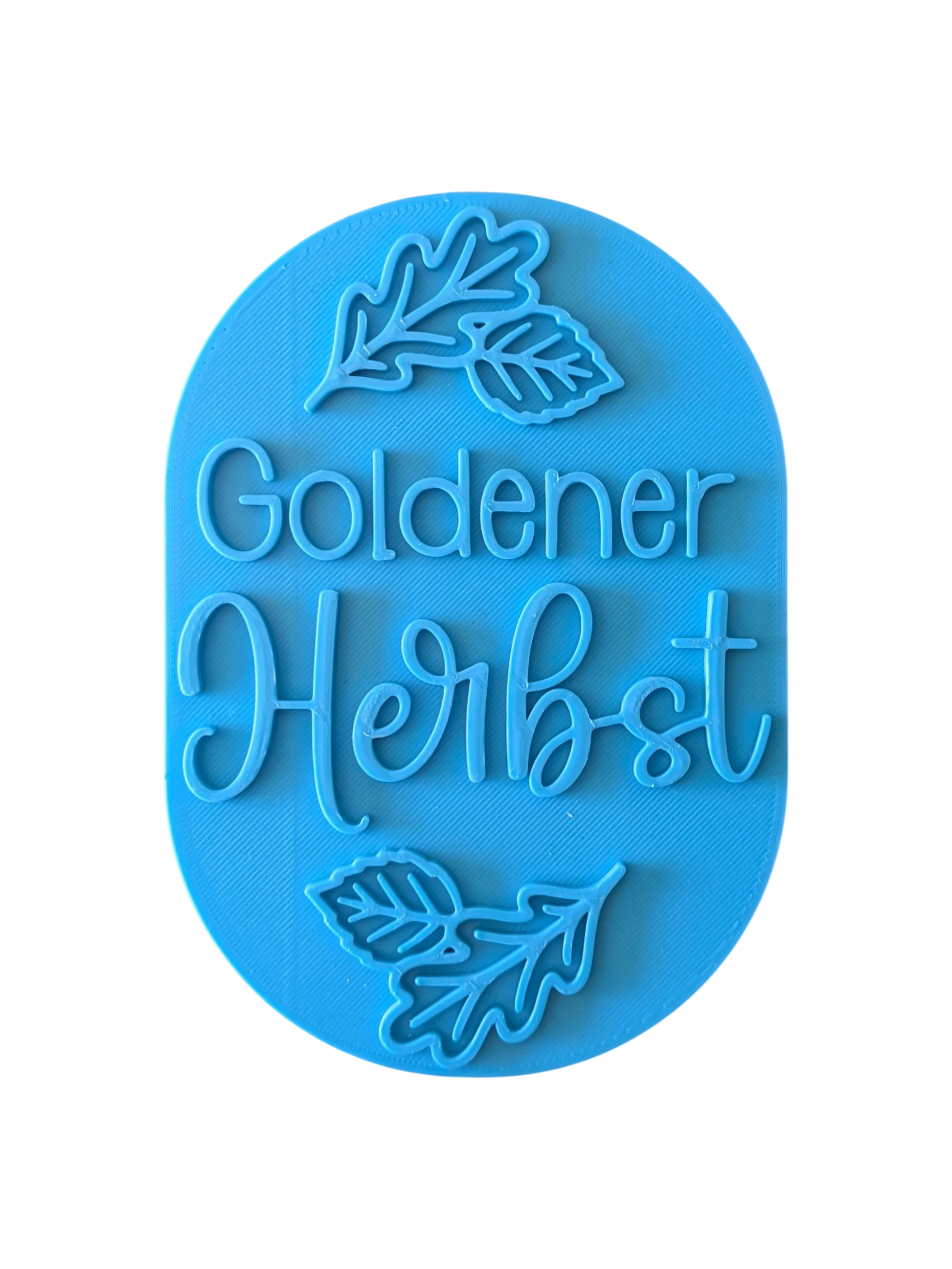 Direkte Draufsicht auf den freigestellten blauen Tonstempel Goldener Herbst mit Herbstblättern.