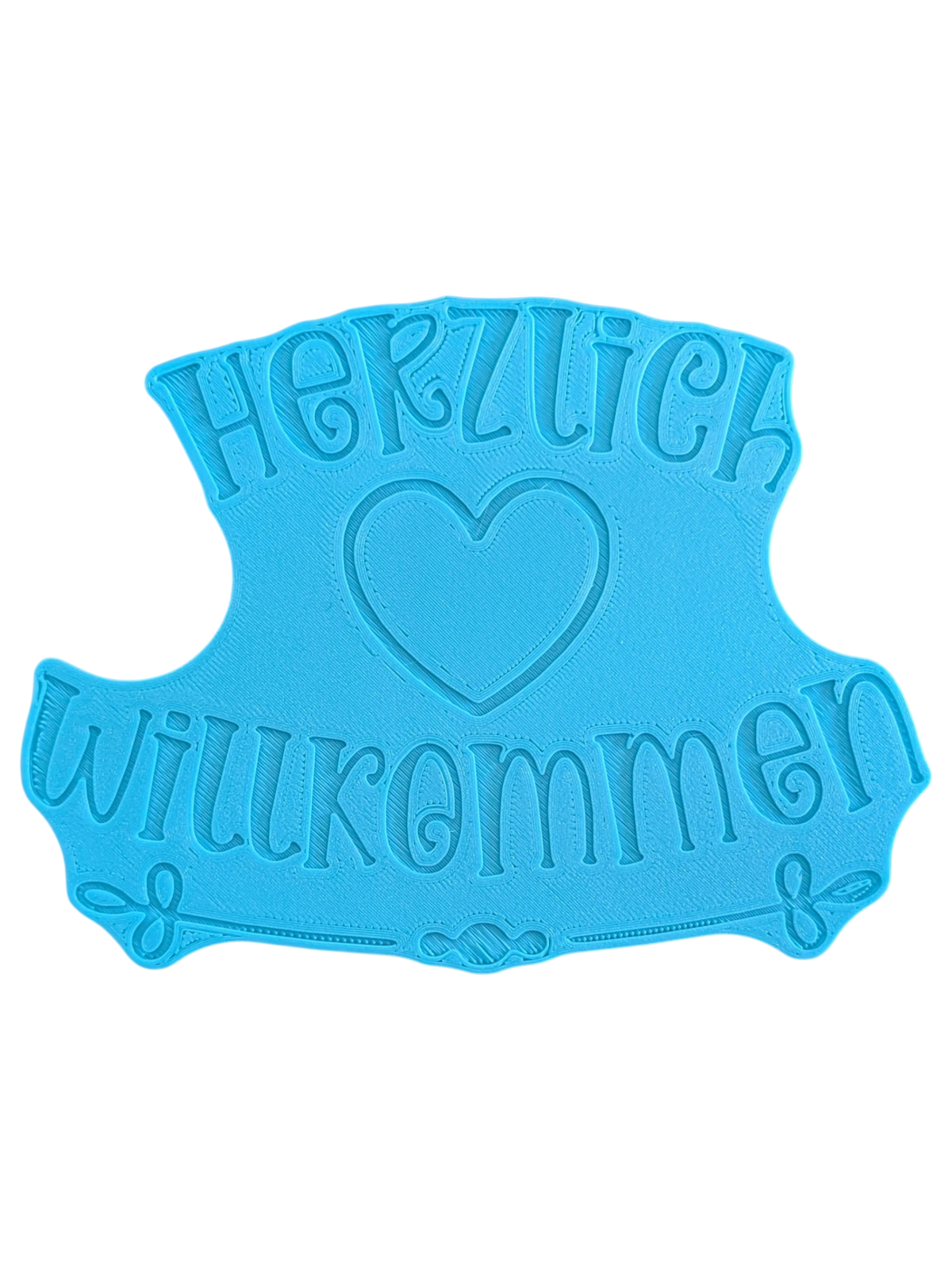 Draufsicht auf die Rückseite auf den blauen Prägestempel mit der Positionierungshilfe für Ton mit dem Schriftzug 'Herzlich Willkommen'. Hochwertiges Töpferwerkzeug für detailreiche Keramikschilder.