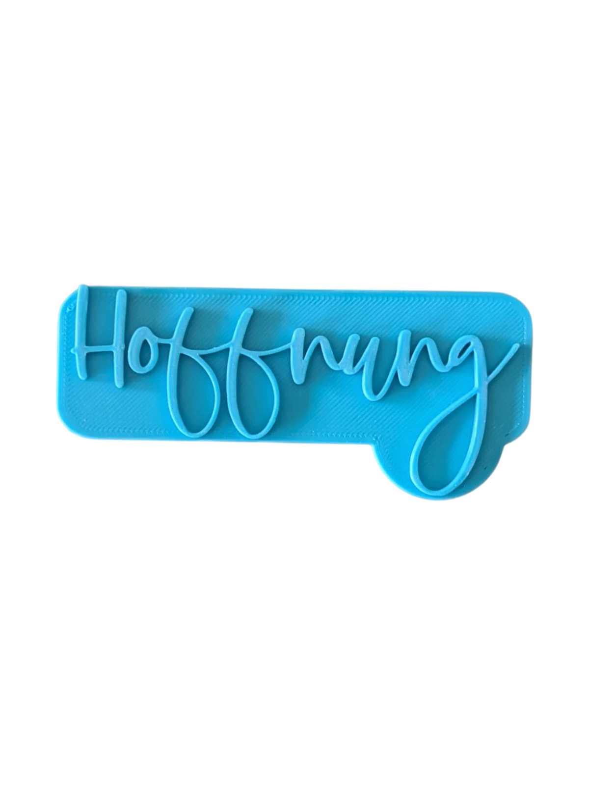 Direkte Draufsicht auf den blauen Tonstempel mit dem Schriftzug Hoffnung und klaren Konturen.