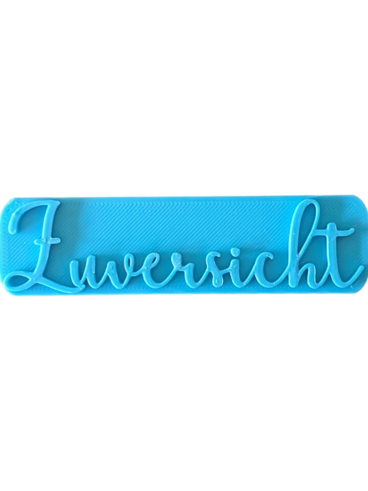 Direkte Draufsicht auf den blauen Tonstempel mit dem Schriftzug Zuversicht und klaren Konturen.