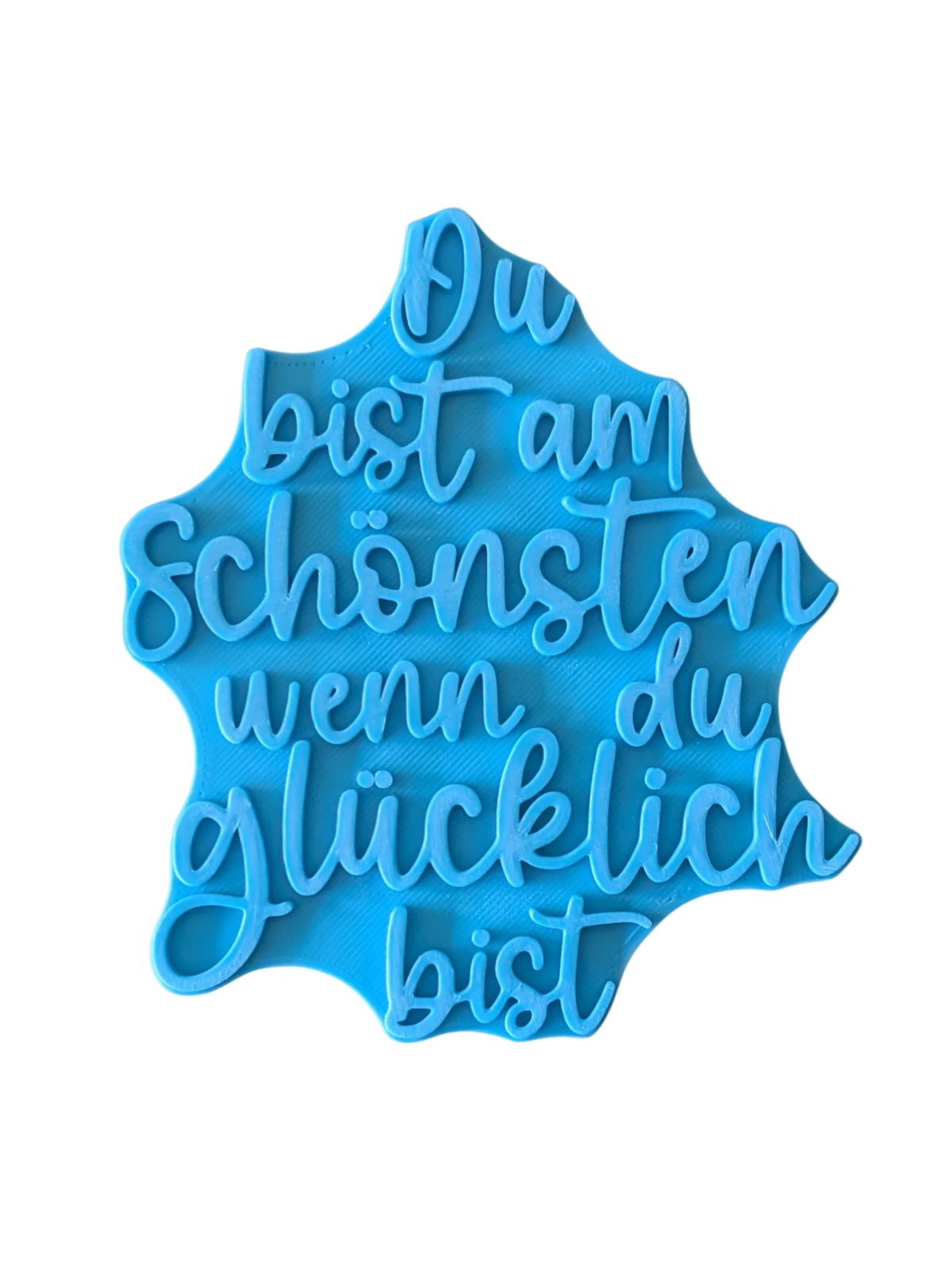 Direkte Draufsicht auf den blauen Tonstempel mit dem Schriftzug Du bist am Schönsten wenn du glücklich bist in 12, 15 und 17 cm.