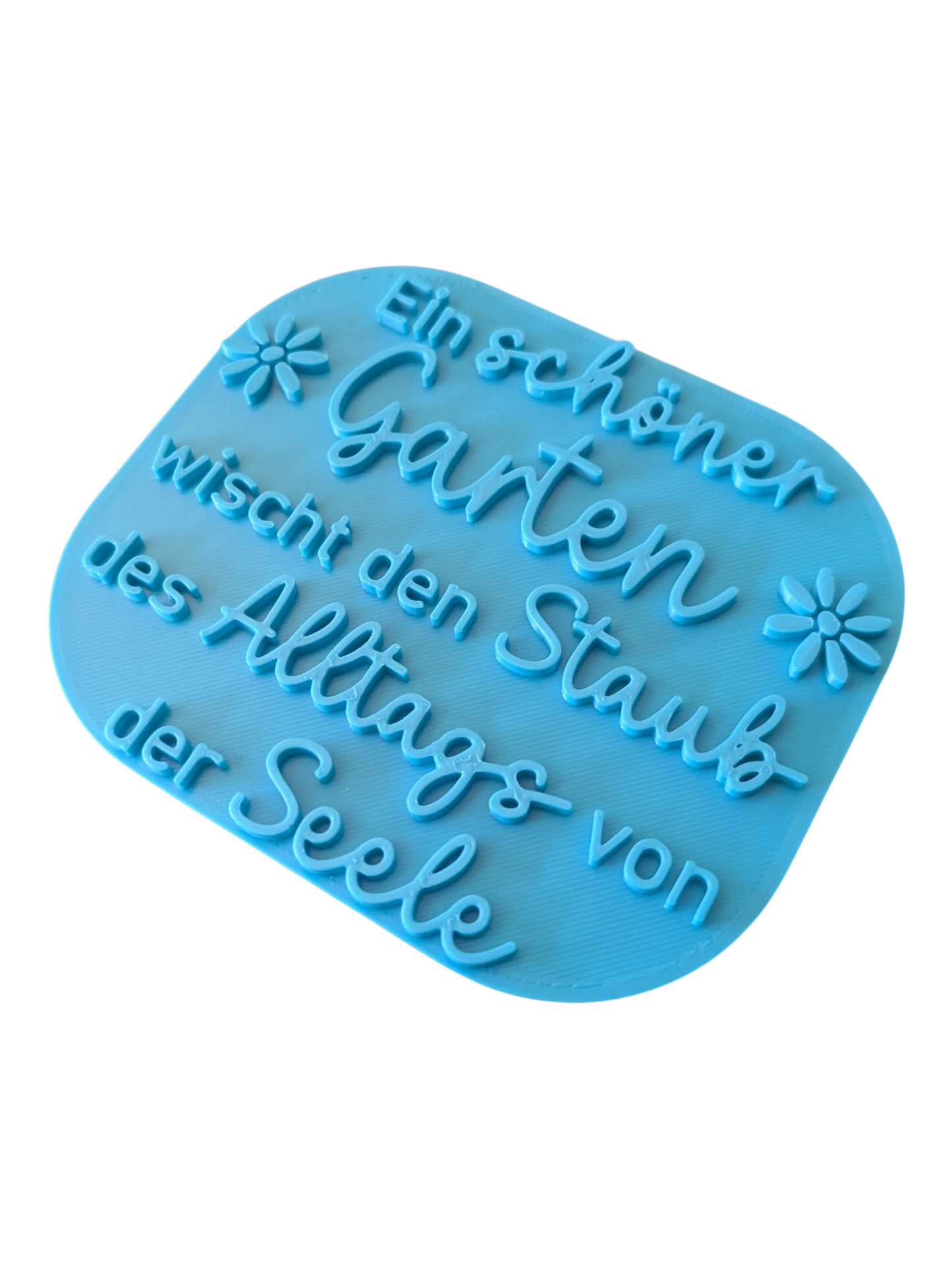 Detailansicht auf den Prägestempel für Ton mit stilisierten Blumen und schwungvoller Schrift. Ideal für Gartendeko und Schilder aus Keramik.
