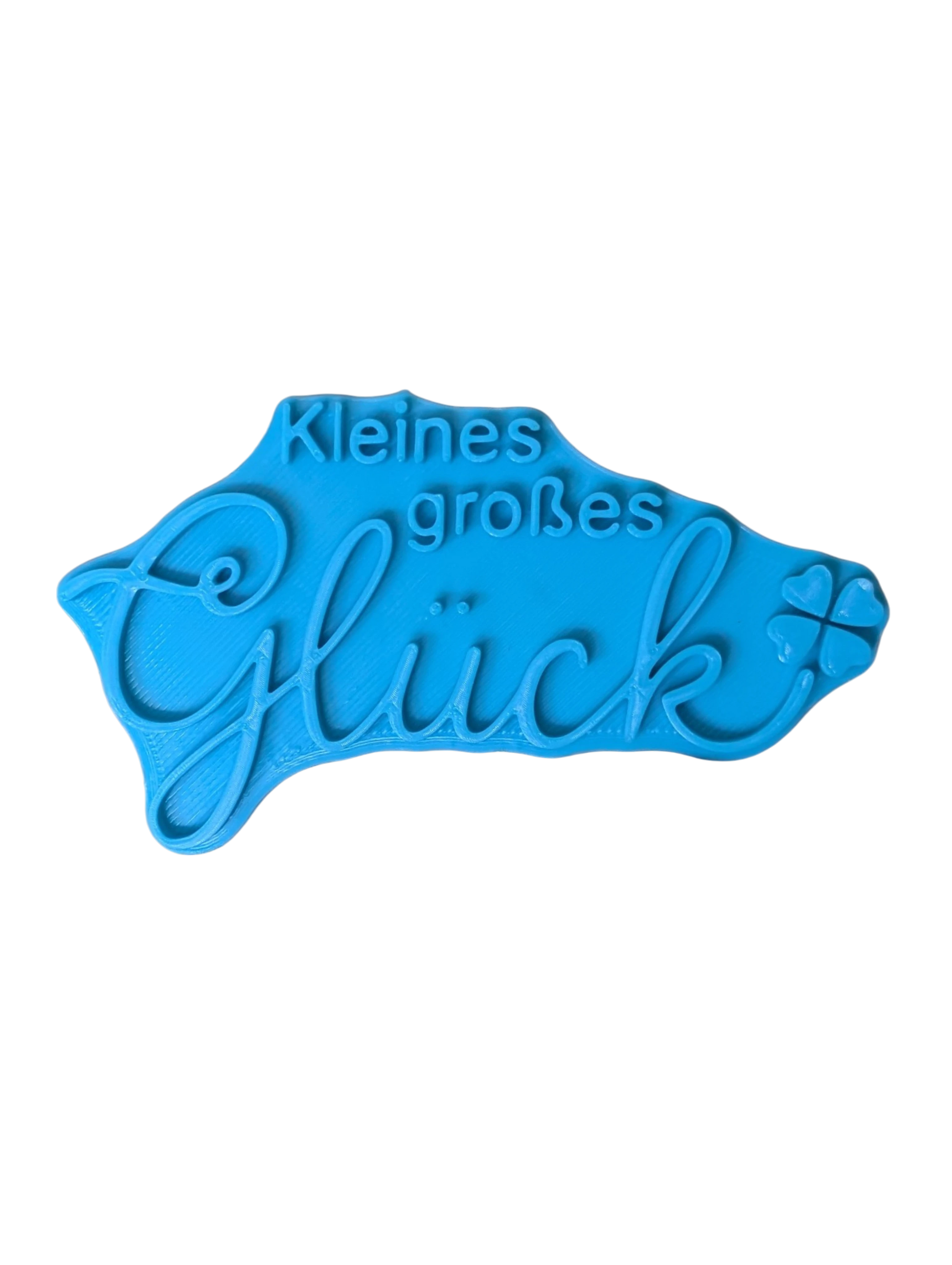 Draufsicht auf den Prägestempel für Ton mit dem Spruch 'Kleines großes Glück'. Ein detailreicher Textstempel für liebevolle Baby-Keramik, Geburtsgeschenke und Kinderzimmer-Deko.