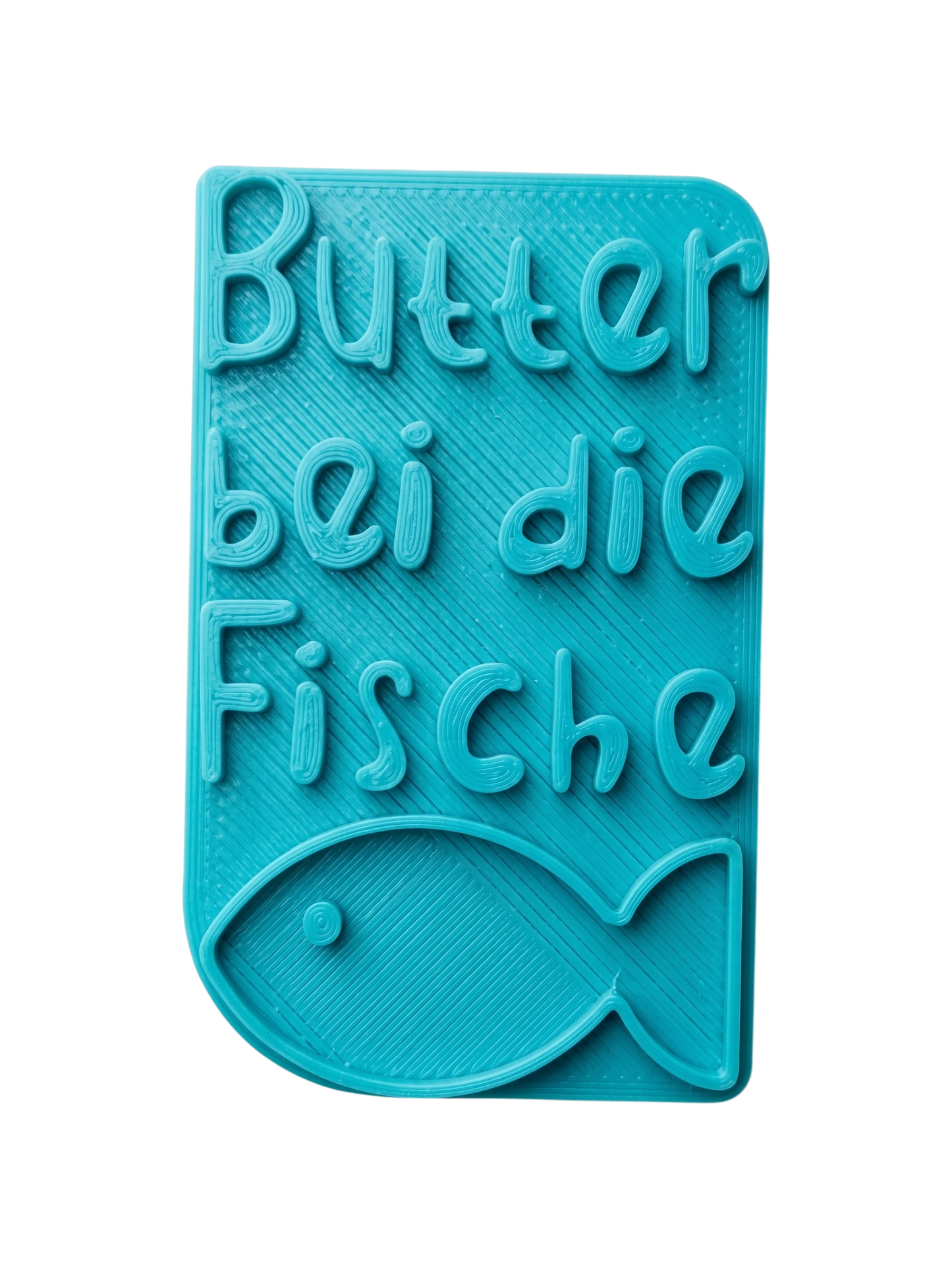 Türkisfarbener Keramikstempel für Ton mit dem Schriftzug 'Butter bei die Fische' und einem kleinen Fisch. Handgefertigtes Töpferwerkzeug für detailreiche Textprägungen.
