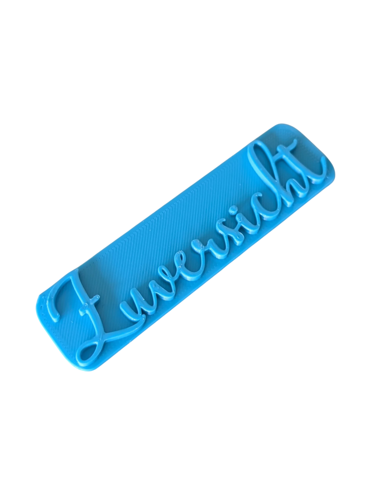 Perspektivische Detailansicht des blauen Stempels mit dem Schriftzug Zuversicht für Töpferarbeiten.